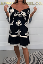 Women's boho dress in black with a flowing skirt, styled for casual and smart-casual outfits.