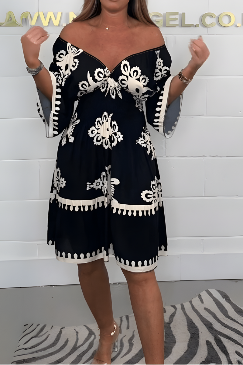Women's boho dress in black with a flowing skirt, styled for casual and smart-casual outfits.