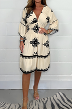 Women's boho dress in beige with a flowing skirt, styled for casual and smart-casual outfits.