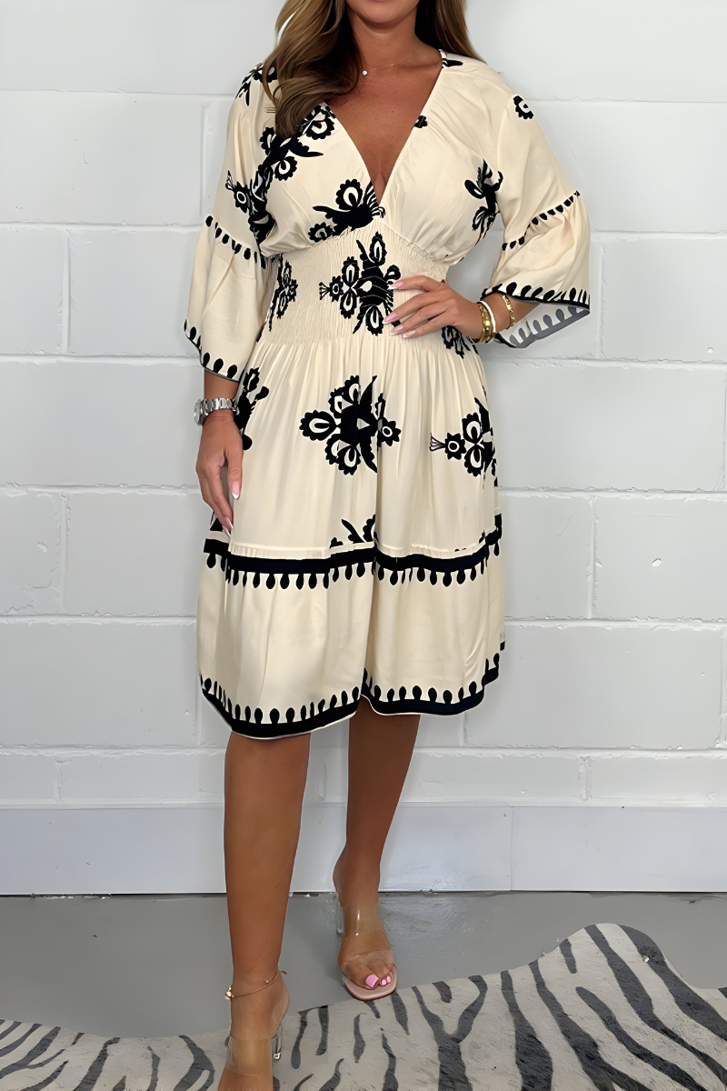 Women's boho dress in beige with a flowing skirt, styled for casual and smart-casual outfits.