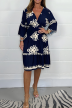 Women's boho dress in navy blue with a flowing skirt, styled for casual and smart-casual outfits.