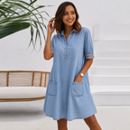 Women's shirt dress in blue with half button placket, styled for casual and smart-casual outfits.