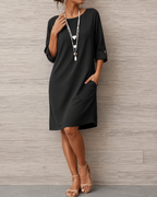 Women's midi dress in black with a flowing skirt, styled for casual and smart-casual outfits.