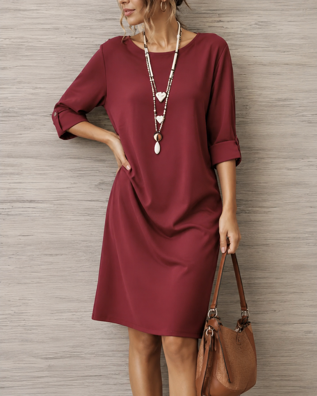Women's midi dress in wine red with a flowing skirt, styled for casual and smart-casual outfits.