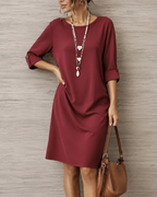 Women's midi dress in wine red with a flowing skirt, styled for casual and smart-casual outfits.