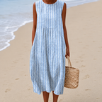 Women's midi dress in blue with a flowing floral print, styled for casual and smart-casual outfits.