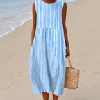 Women's midi dress in light blue with a painterly floral print, styled for casual and smart-casual outfits.
