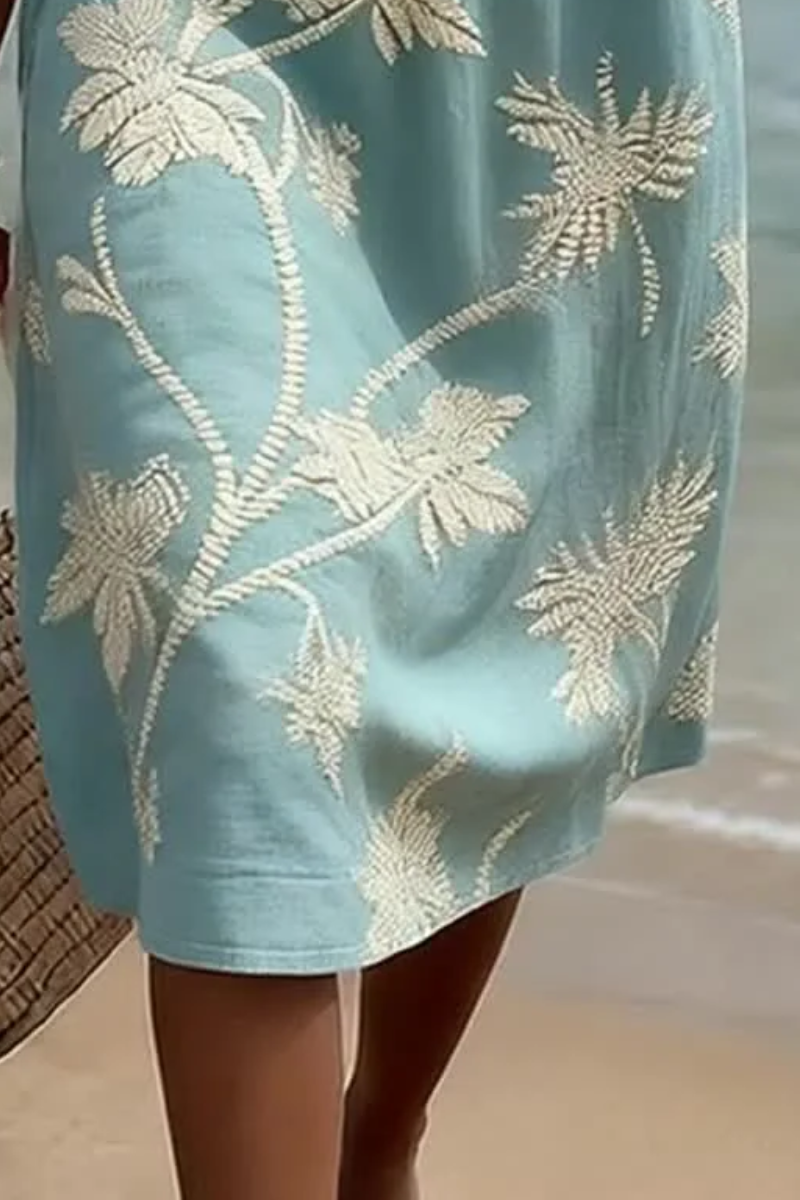 Women's midi dress in light blue with floral print, styled for casual and smart-casual outfits.
