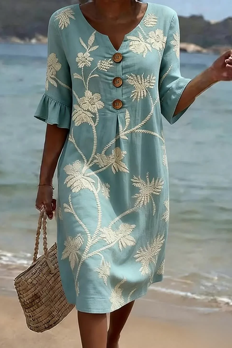 Women's midi dress in light blue with floral print, styled for casual and smart-casual outfits.