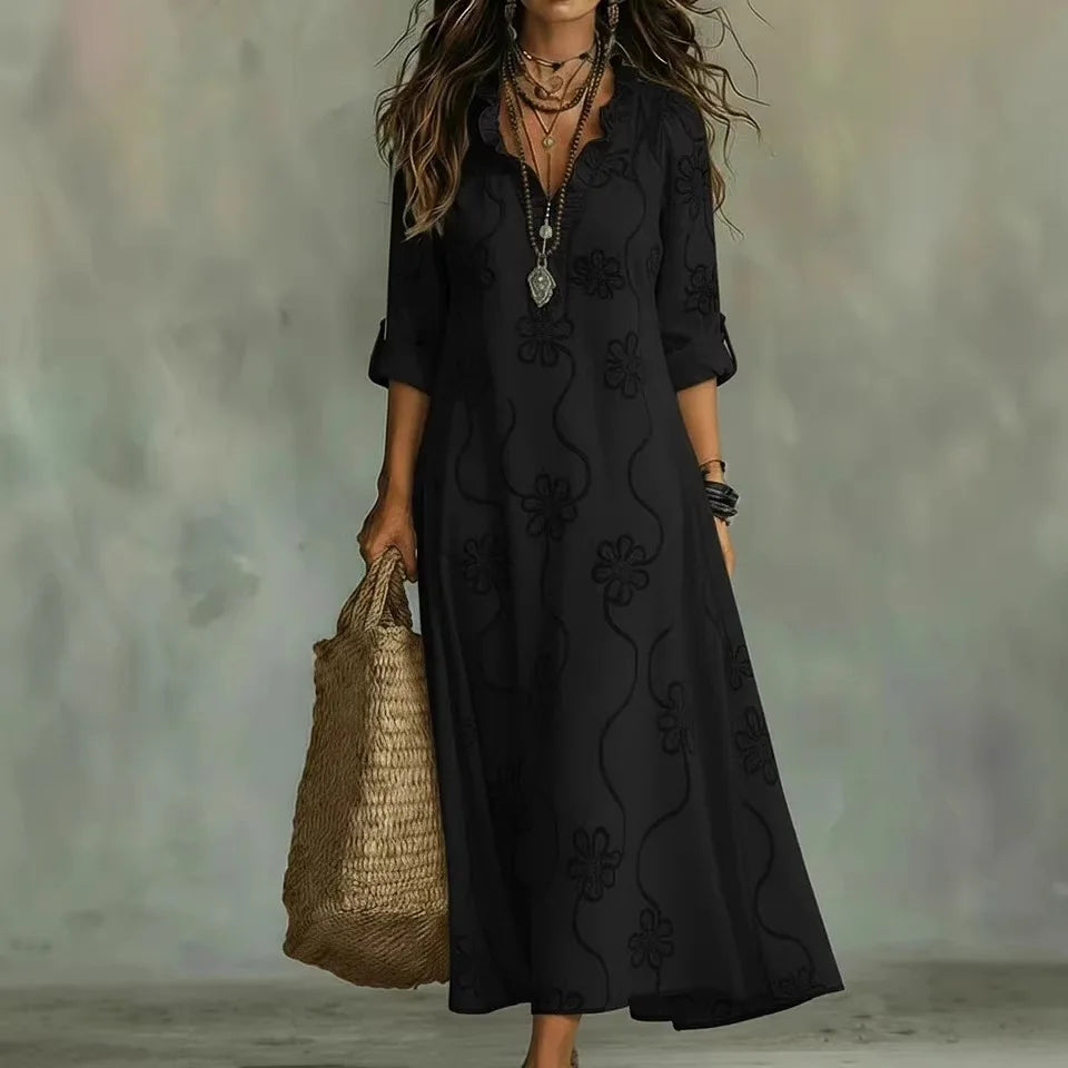 Women's floral summer dress in black with roll-up sleeves, styled for casual and smart-casual outfits.