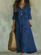 Women's floral summer dress in navy blue with roll-up sleeves, styled for casual and smart-casual outfits.