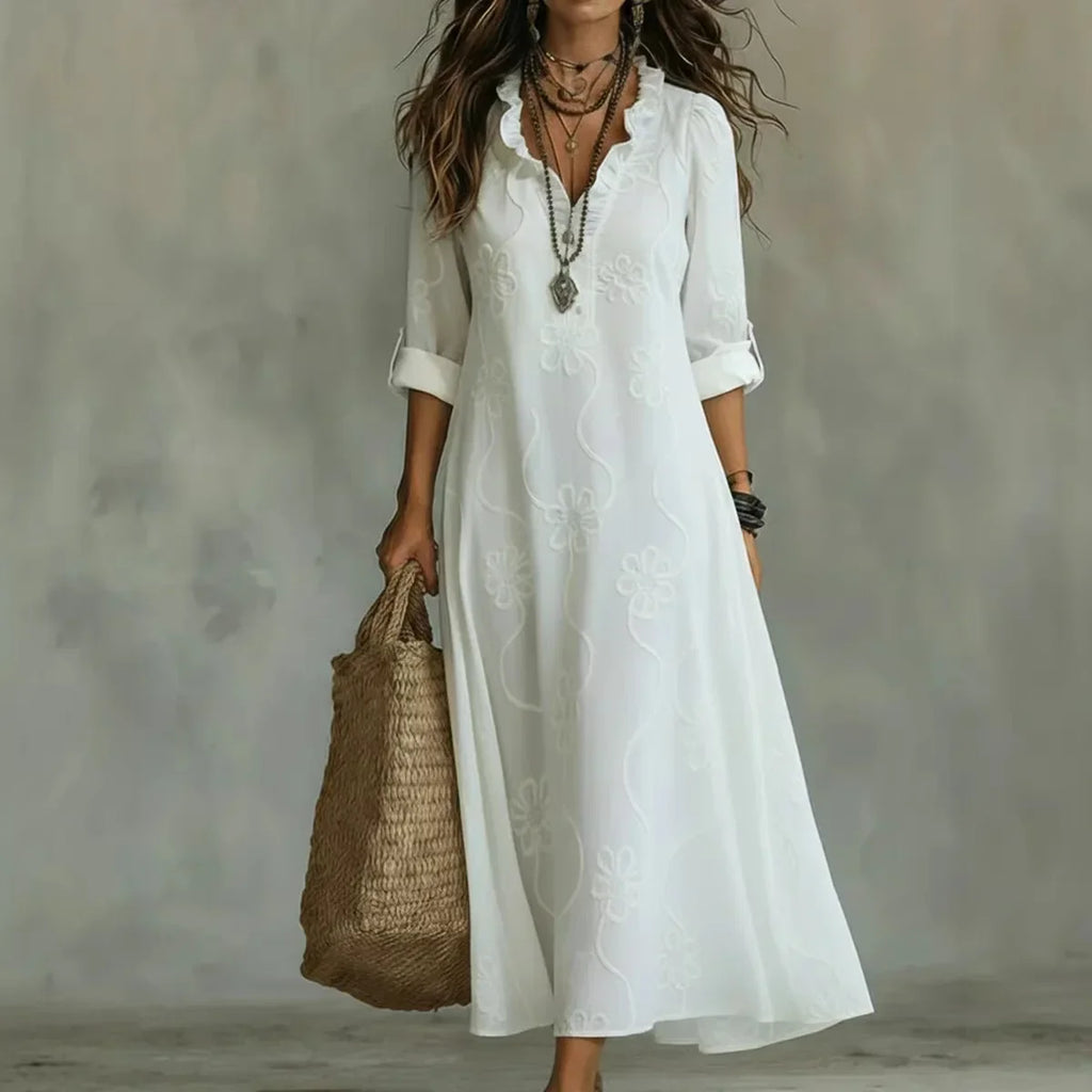 Women's floral summer dress in white with roll-up sleeves, styled for casual and smart-casual outfits.