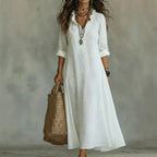 Women's floral summer dress in white with roll-up sleeves, styled for casual and smart-casual outfits.