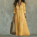 Women's floral summer dress in yellow with roll-up sleeves, styled for casual and smart-casual outfits.