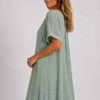 Women's maxi dress in peacock green with V-neckline, styled for casual and smart-casual outfits.