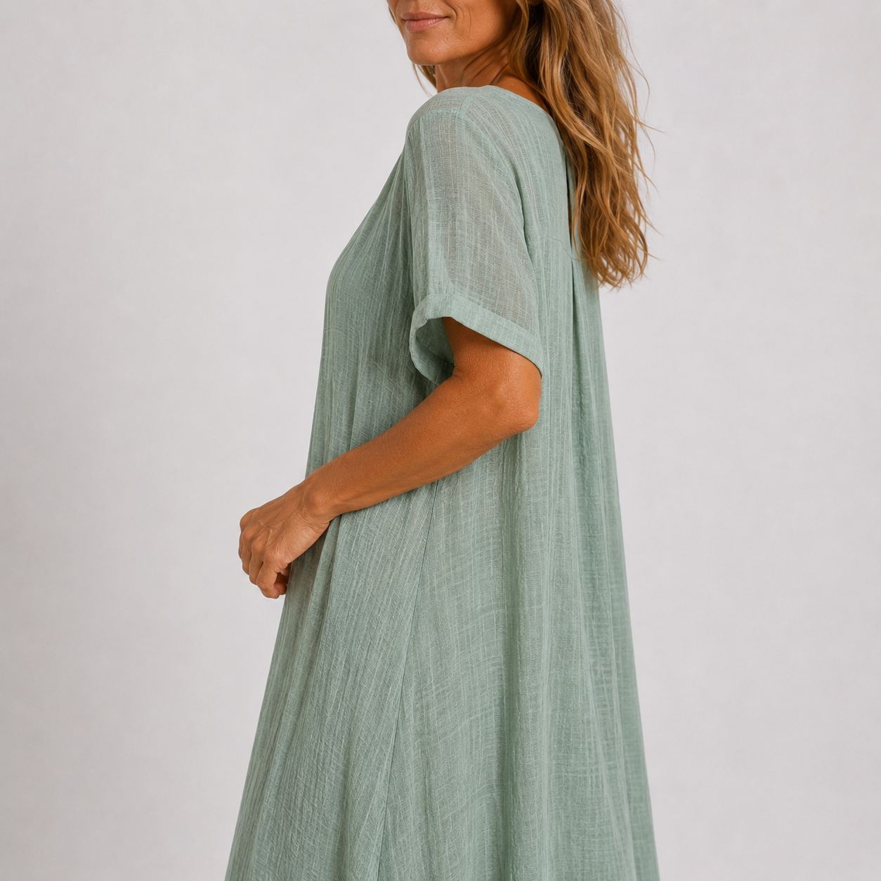 Women's maxi dress in peacock green with V-neckline, styled for casual and smart-casual outfits.