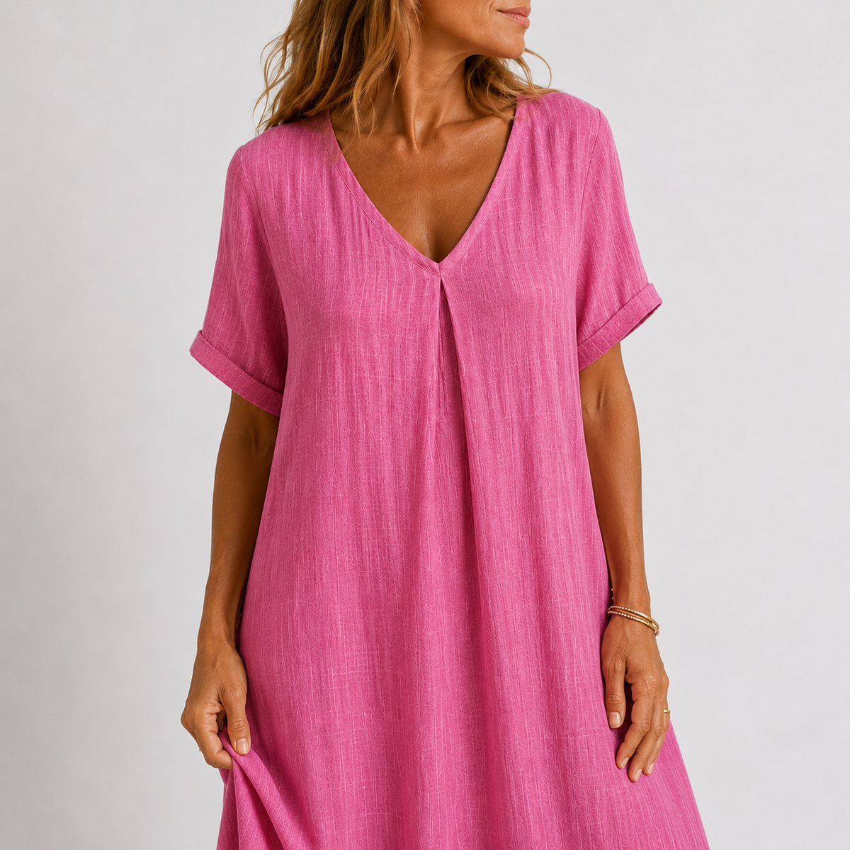 Women's maxi dress in peacock green with V-neckline, styled for casual and smart-casual outfits.