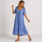Women's maxi dress in navy blue with V-neckline, styled for casual and smart-casual outfits.