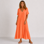 Women's maxi dress in orange red with V-neckline, styled for casual and smart-casual outfits.