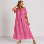 Women's maxi dress in pink with V-neckline, styled for casual and smart-casual outfits.