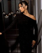 Women's maxi dress in black with a glittering finish, styled for evening and smart-casual outfits.