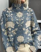Women's knitted jumper in blue with graphic print, styled for casual and smart-casual outfits.