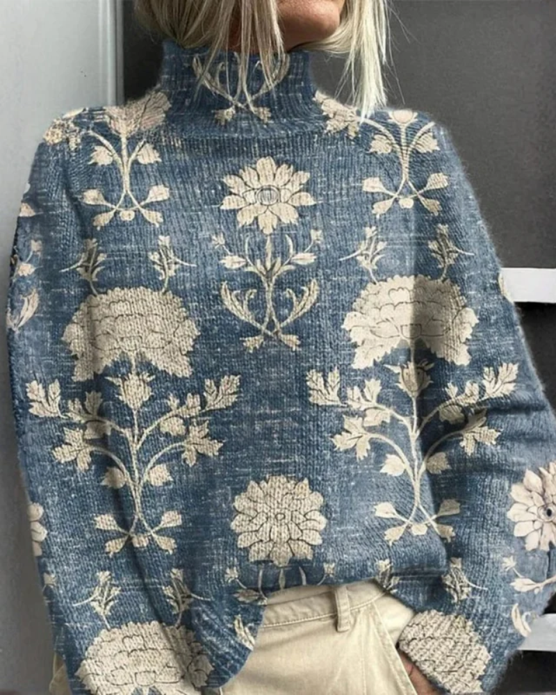 Women's knitted jumper in blue with graphic print, styled for casual and smart-casual outfits.