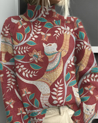 Women's knitted jumper in red with graphic print, styled for casual and smart-casual outfits.