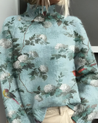 Women's knitted jumper in sea blue with graphic print, styled for casual and smart-casual outfits.