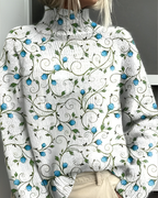 Women's knitted jumper in white with graphic print, styled for casual and smart-casual outfits.