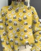 Women's knitted jumper in yellow with graphic print, styled for casual and smart-casual outfits.
