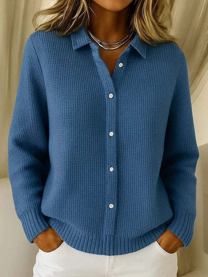 Women's knitted jumper in blue with collar, styled for casual and smart-casual outfits.