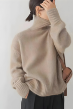 Women’s roll-neck jumper in beige with high knitted collar, styled for casual and smart-casual outfits.