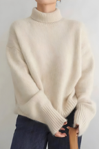 Women’s roll-neck jumper in beige with high knitted collar, styled for casual and smart-casual outfits.