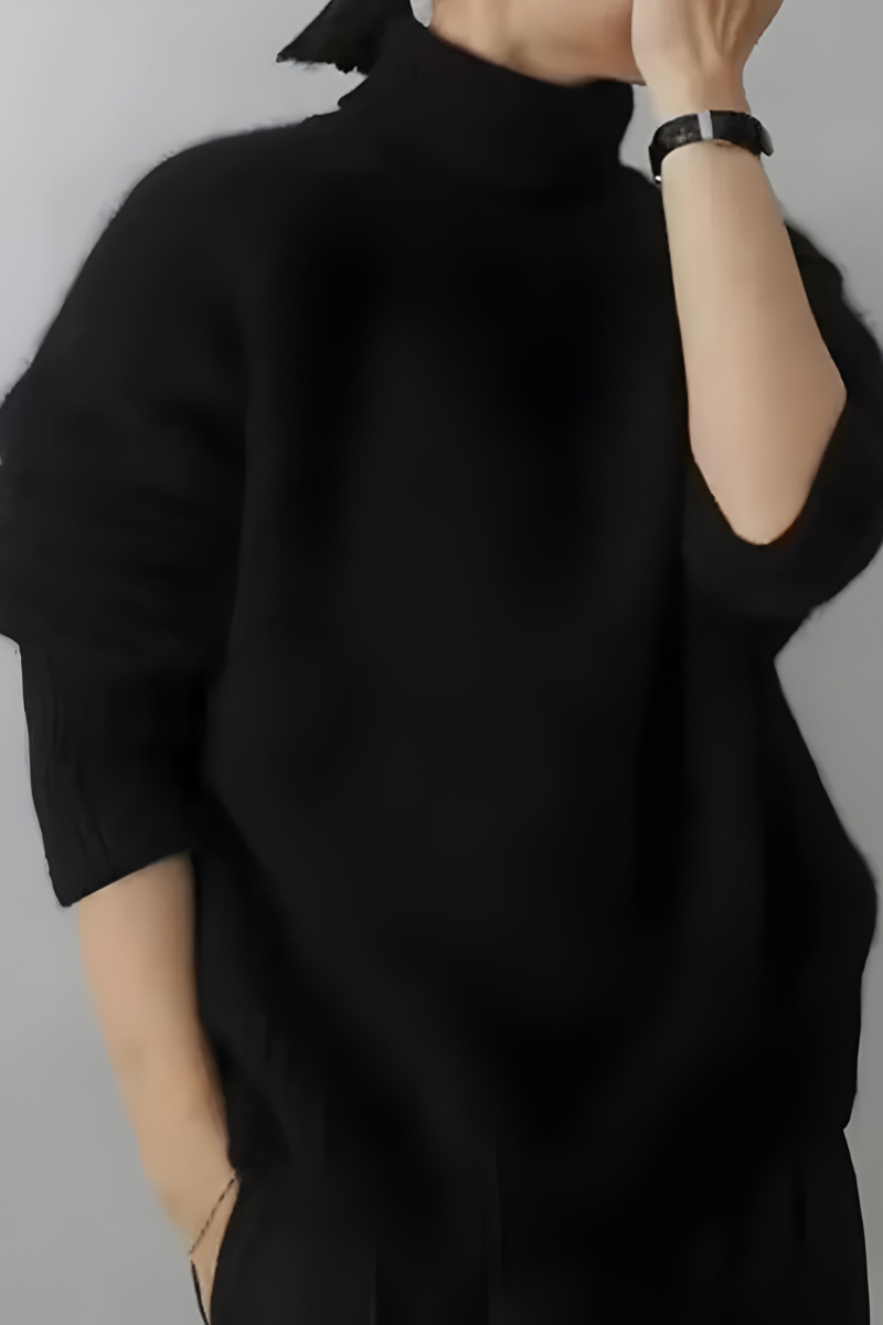 Women’s roll-neck jumper in black with high knitted collar, styled for casual and smart-casual outfits.