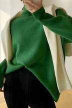 Women’s roll-neck jumper in green with high knitted collar, styled for casual and smart-casual outfits.