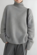 Women’s roll-neck jumper in grey with high knitted collar, styled for casual and smart-casual outfits.