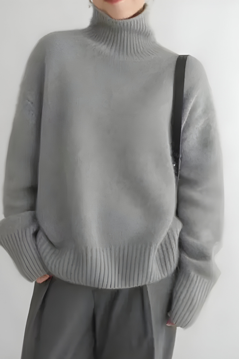 Women’s roll-neck jumper in grey with high knitted collar, styled for casual and smart-casual outfits.