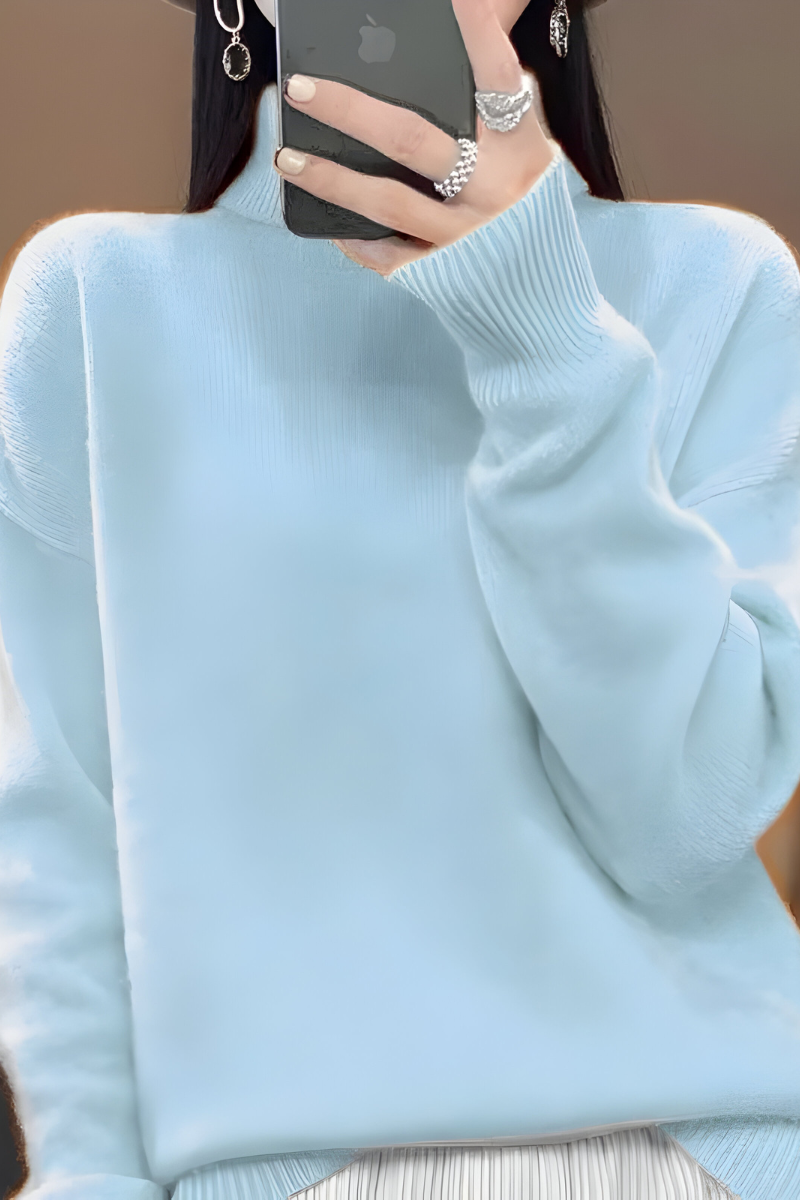 Women’s roll-neck jumper in light blue with high knitted collar, styled for casual and smart-casual outfits.