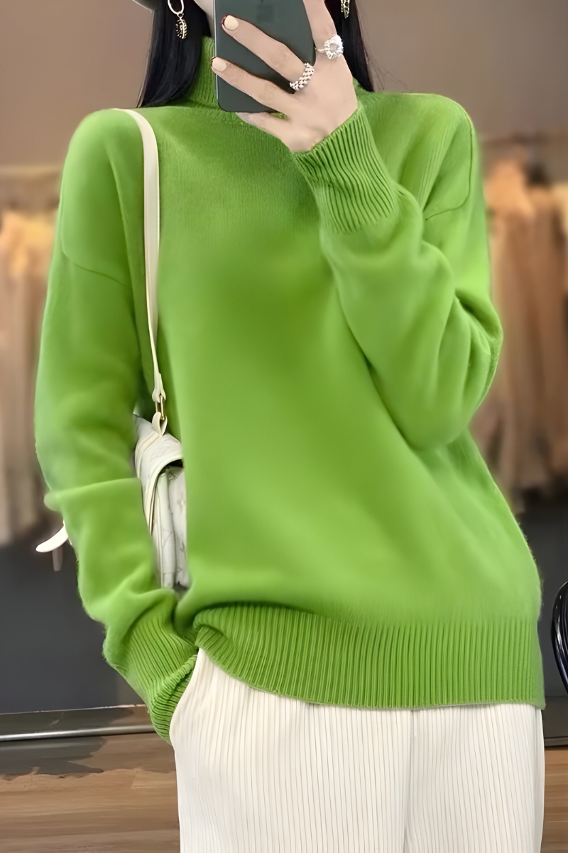 Women’s roll-neck jumper in light green with high knitted collar, styled for casual and smart-casual outfits.
