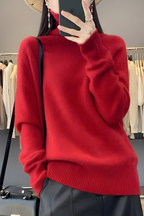 Women’s roll-neck jumper in red with high knitted collar, styled for casual and smart-casual outfits.