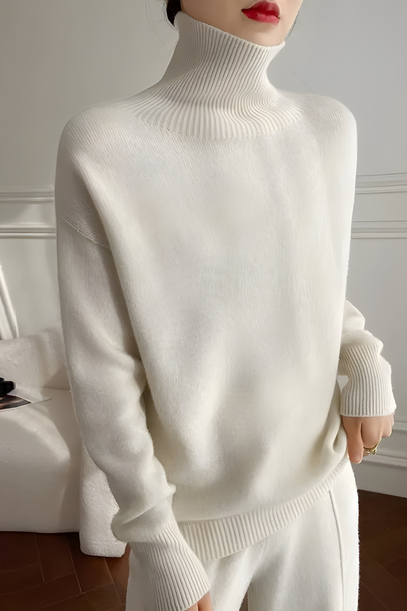 Women’s roll-neck jumper in white with high knitted collar, styled for casual and smart-casual outfits.