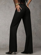 Women's loose fit trousers in black with a high waistband, styled for casual and smart-casual outfits.