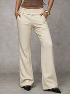 Women's loose fit trousers in beige with a high waistband, styled for casual and smart-casual outfits.