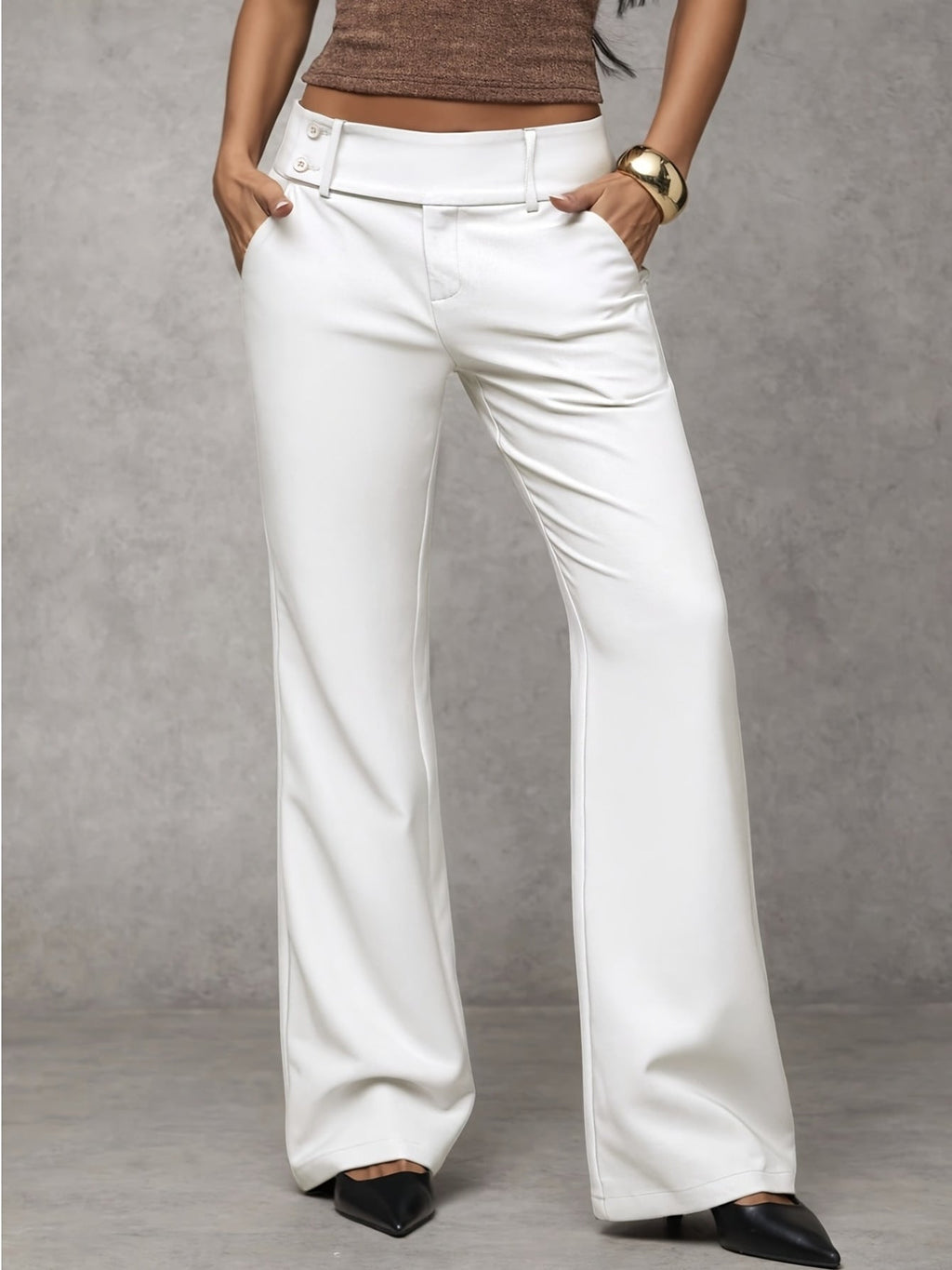 Women's loose fit trousers in white with a high waistband, styled for casual and smart-casual outfits.