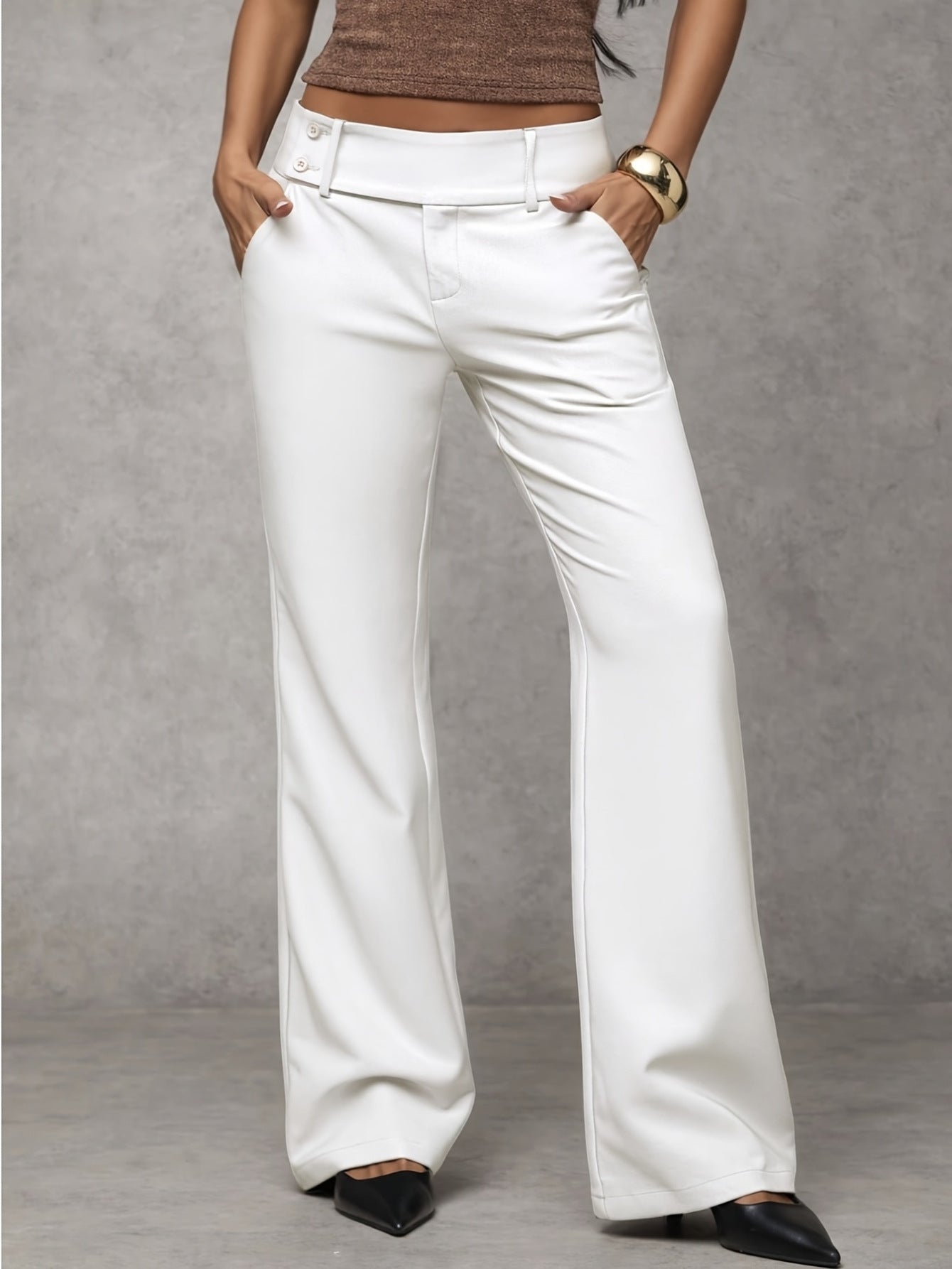 Women's loose fit trousers in white with a high waistband, styled for casual and smart-casual outfits.