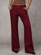 Women's loose fit trousers in wine red with straight legs, styled for casual and smart-casual outfits.