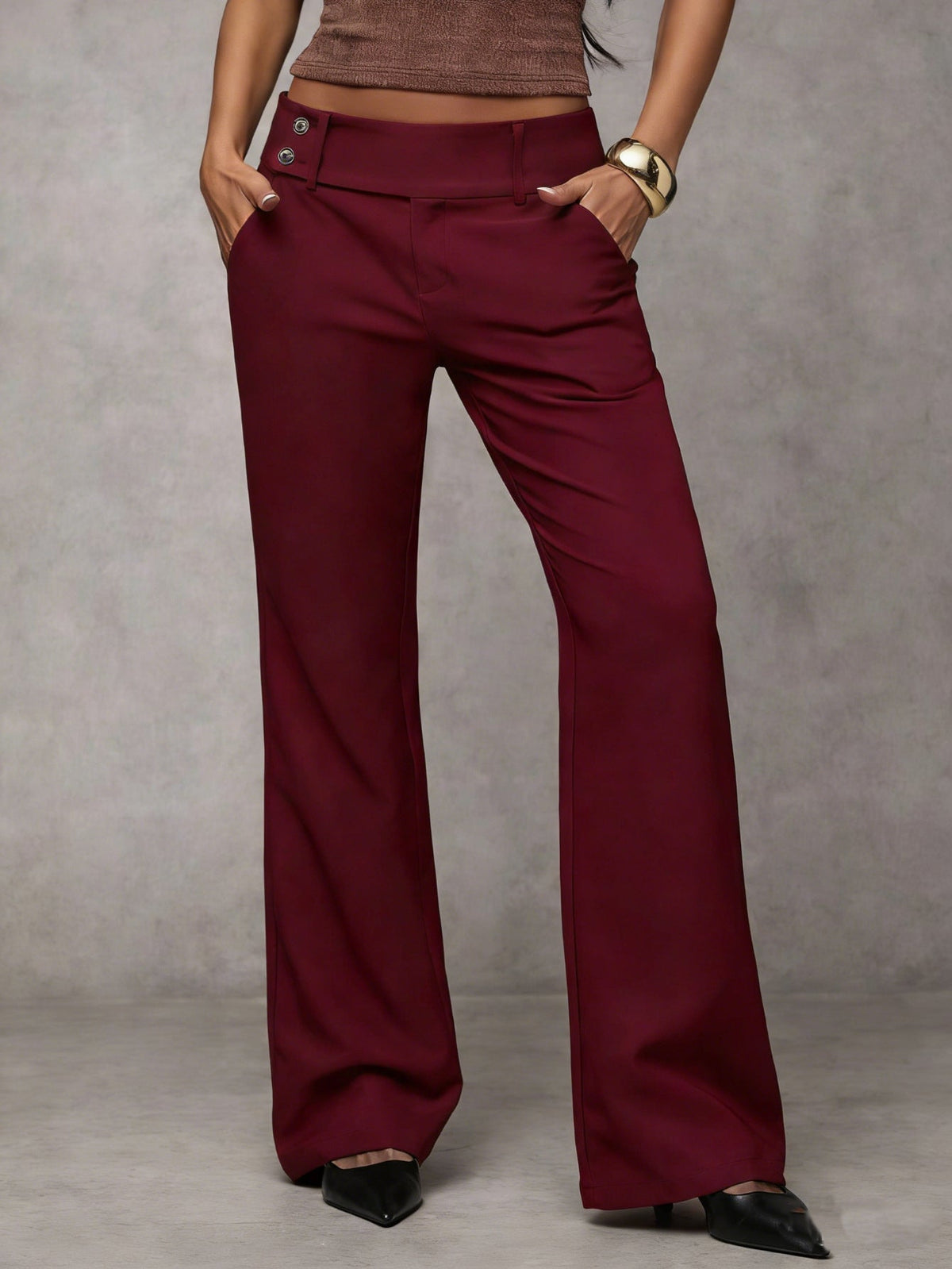 Women's loose fit trousers in wine red with straight legs, styled for casual and smart-casual outfits.