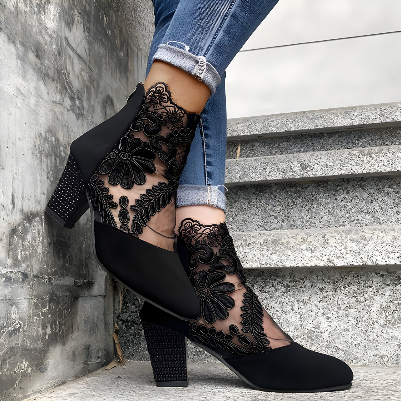 Women's orthopaedic heels in black with a wide toe box, styled for casual and smart-casual outfits.