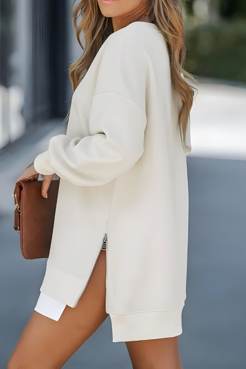 Women’s oversized jumper in apricot with side zip detail, styled for casual and smart-casual outfits.